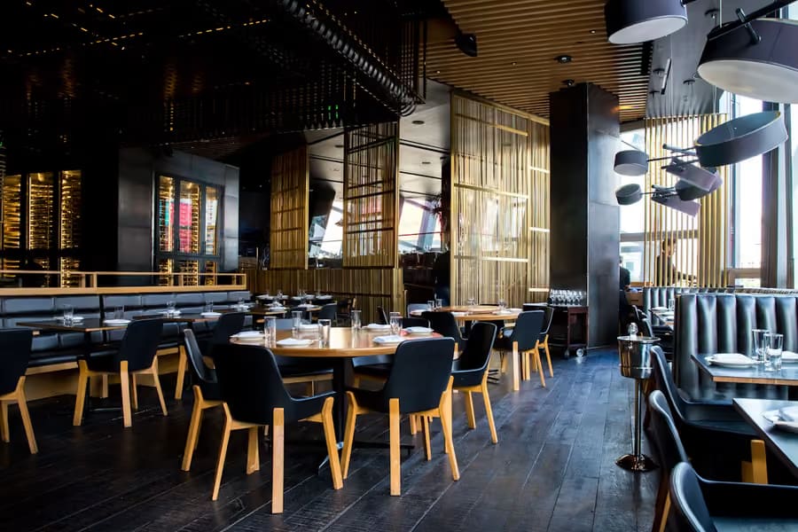 Restaurant dining room with wooden tables and upholstered benches